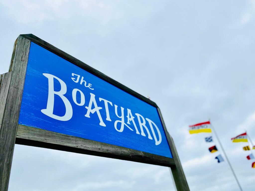 The Boatyard sign with flags